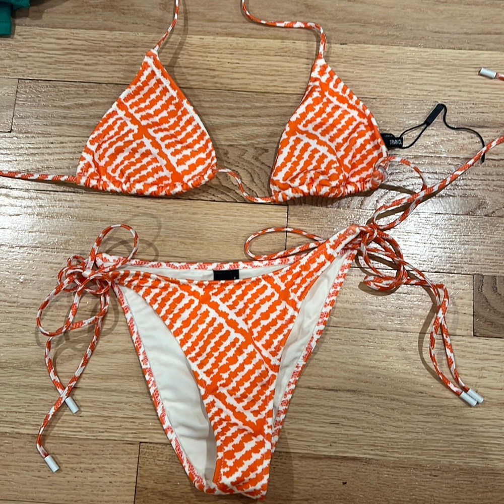 Orange/White Bikini Triangl. Top is a size large, and bottoms are medium, cheeky